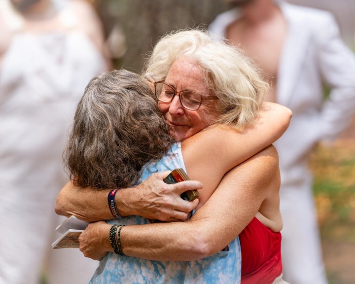 Two festival attendees sharing a hug