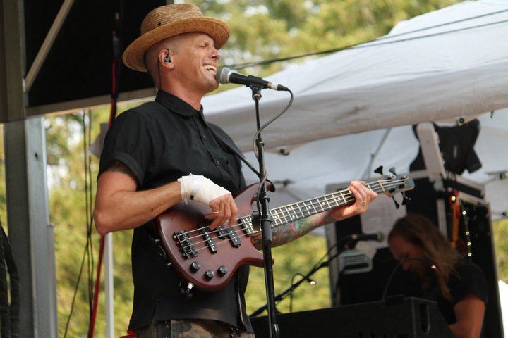 Singer playing guitar on the outdoor stage