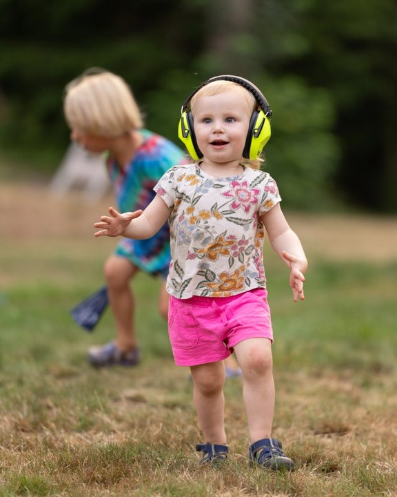 Children playing on the grassy festival grounds