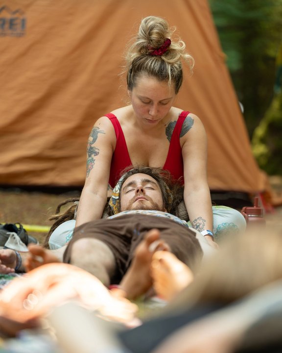 A seated participant receiving a massage at the festival