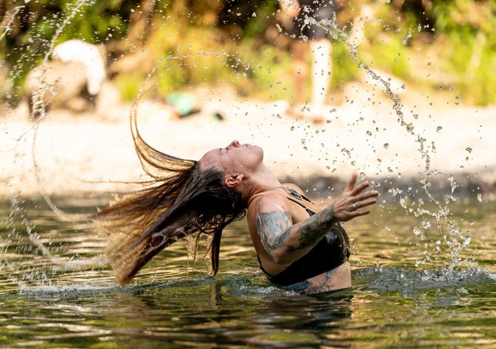 Festival attendee splashing in the river