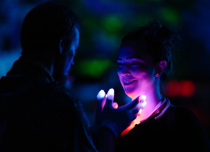 Festival attendees smiling together under colorful lights